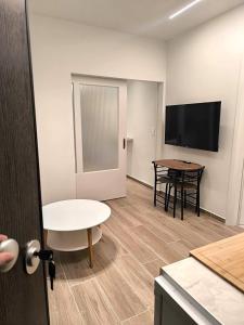 a living room with a table and a television at Kiato City Stay in Kiaton