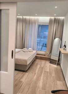 a bedroom with a bed and a view of a balcony at Kiato City Stay in Kiaton