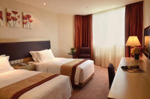 Voodi või voodid majutusasutuse Grandview Hotel Macau toas