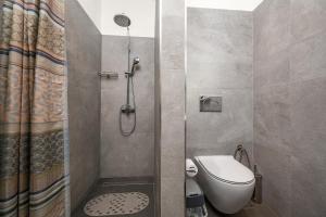 a bathroom with a shower with a toilet and a sink at Villa Belo in Kastrí +39 photos