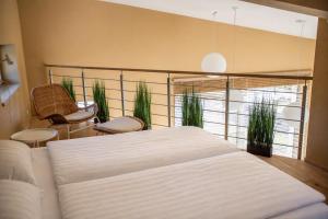 a bedroom with a bed and some plants in it at Amenity Usedlost v Marinkách in Blažejov