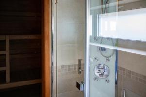 a bathroom with a shower with a glass door at Amenity Usedlost v Marinkách in Blažejov