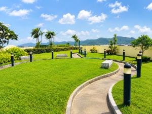 a park with a grassy field and a pathway at Apartment Phuket Old Town Fast Wifi Netflix Pool Gym Cityview in Phuket