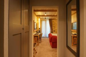 a bedroom with a bed and a desk in a room at Alpin Resort Hotel in Poiana Brasov +86 photos
