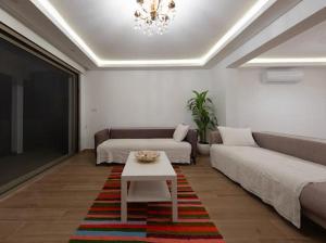 a living room with a couch and a table at BODRUM BURCU RESIDENCE, Magnificent Sea View, Cozy, Free Otopark, Free Wifi in Bodrum City