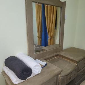 a bathroom with a mirror and towels on a dresser at Enjoy Life Holidays in Andrés +16 photos