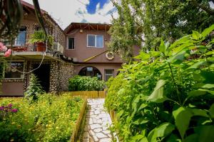 a house with a walkway in front of a garden at Casa Yachi Vama Veche in Vama Veche
