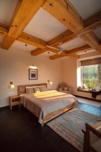 a bedroom with a large bed and a window at The Chitai Life in Almora