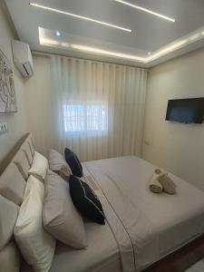 a bedroom with a large white bed with pillows at Dar marhaba in Tangier +17 photos