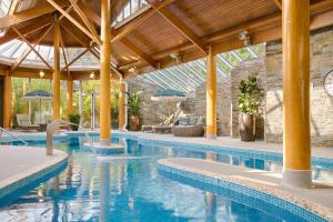 an indoor swimming pool with a patio and an indoor at Sheen Falls Lodge in Kenmare