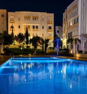 a large blue swimming pool in front of a building at Dar marhaba in Tangier