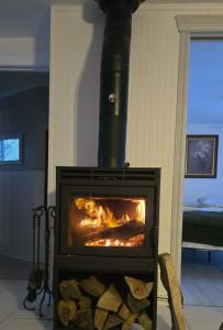 a stove with a fire in a room at River & Nature - Nook Richelieu in Henryville