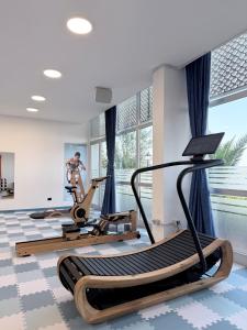 a gym with two treadmills and a treadmill at JR Resort Elba International in Capoliveri