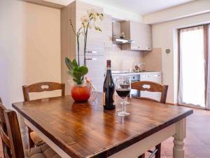 a wooden table with a bottle of wine and two glasses at L'Uggetto in Montecastrilli +10 photos