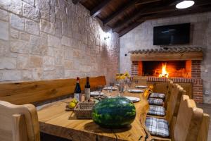 a dining room with a table with a water melon on it at Kuća za odmor Leona in Dušić