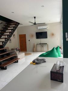 a living room with a couch and a staircase at NEW! Sunset & Seaview Pool Villa in Ko Ma