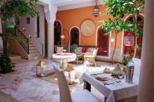 a living room with a table and chairs at Riad Nirvana in Marrakesh