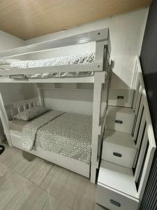 a bedroom with a bunk bed and a staircase at A.C. Asistin Transient House in Baguio