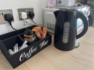 a black coffee pot sitting on top of a counter at Cosy Private Bedrooms in Euston Station in London