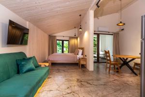 a living room with a couch and a bed at Апарт- готель SunRay Skhidnytsya in Skhidnitsa +80 photos