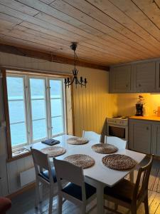 a kitchen with a table and chairs in a kitchen at Skjellfjord cabin in Skjelfjord
