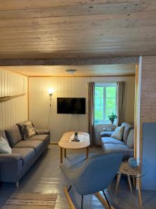 a living room with a couch and a table at Skjellfjord cabin in Skjelfjord