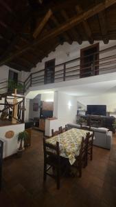 a living room with a table and chairs and a couch at La Dimora del Grifo in Mascalucia
