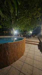 a swimming pool with a fence around it at night at La Dimora del Grifo in Mascalucia