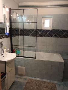 a bathroom with a tub and a sink at Chalupa Za zeleným plotom in Pača +19 photos