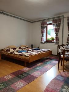 a bedroom with a large bed in a room at Chalupa Za zeleným plotom in Pača