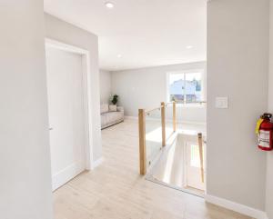 a white room with a staircase and a window at Wonderful house in Niagara-on-the-Lake