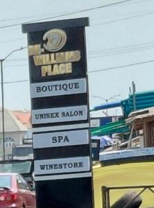 a sign for a sushi place with cars in a parking lot at DE-WILLIAMS PLACE hotel in Ibadan