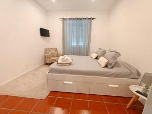 a bedroom with a bed and a tv in it at Casa Teles in Peso da Régua