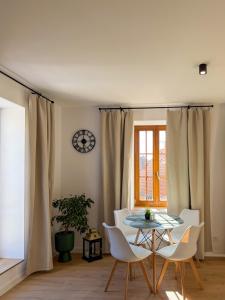 a dining room with a table and chairs and a clock at Spim na Rabí in Raby +20 photos