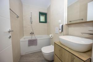 a bathroom with a sink and a toilet and a shower at Beachfront Villa San't Antonio Podaca in Podaca +68 photos