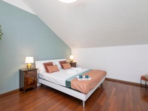 a bedroom with a bed with white sheets and orange pillows at NoLo Uptown Milano in Milan