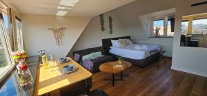 a small room with a bed and a couch at Sunnyzandvoort in Zandvoort