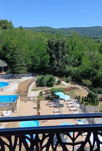 a view of a swimming pool with chairs and umbrellas at Vrdnik Residence Apartments 33 in Vrdnik