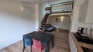 a kitchen and dining room with a table and chairs at Maison bord de Loire Listing B in Saint-Rémy-la-Varenne