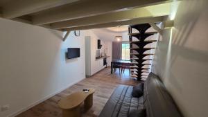 a living room with a couch and a dining room at Maison bord de Loire Listing B in Saint-Rémy-la-Varenne