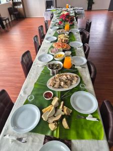 a long table with plates of food on it at Standard - Bluelight Village Hotel in Nadi +45 photos