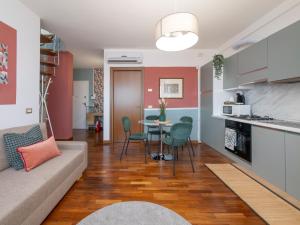 a living room with a couch and a table at NoLo Uptown Milano in Milan