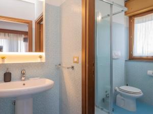 a bathroom with a sink and a toilet and a glass shower at NoLo Uptown Milano in Milan