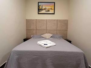 a bedroom with a bed with a towel on it at Pousada Castelinho in São Sebastião