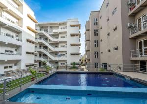 a swimming pool in front of two apartment buildings at DOMO By Design Union in Lagos