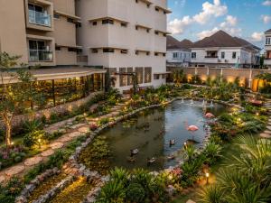 an aerial view of a hotel with ducks in a pond at DOMO By Design Union in Lagos