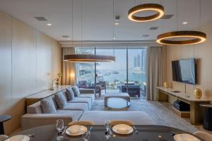 a living room with a large couch and a tv at Vacationer Holiday Homes I Opulent 2 Bedroom I Sea View I Beach Access l FIVE Palm in Dubai +27 photos