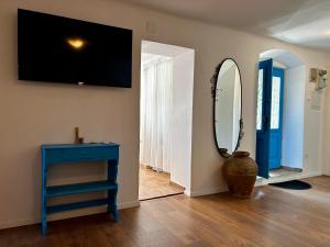a room with a blue table and a mirror at Island Life in Mali Lošinj