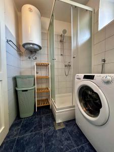 a washing machine in a bathroom with a shower at Island Life in Mali Lošinj +3 photos