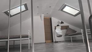 a attic room with two benches and windows at Casa Sole in Murg